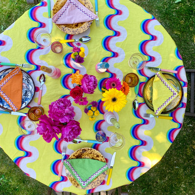 Birds eye view of a tablescape including a rainbow wave tablecloth